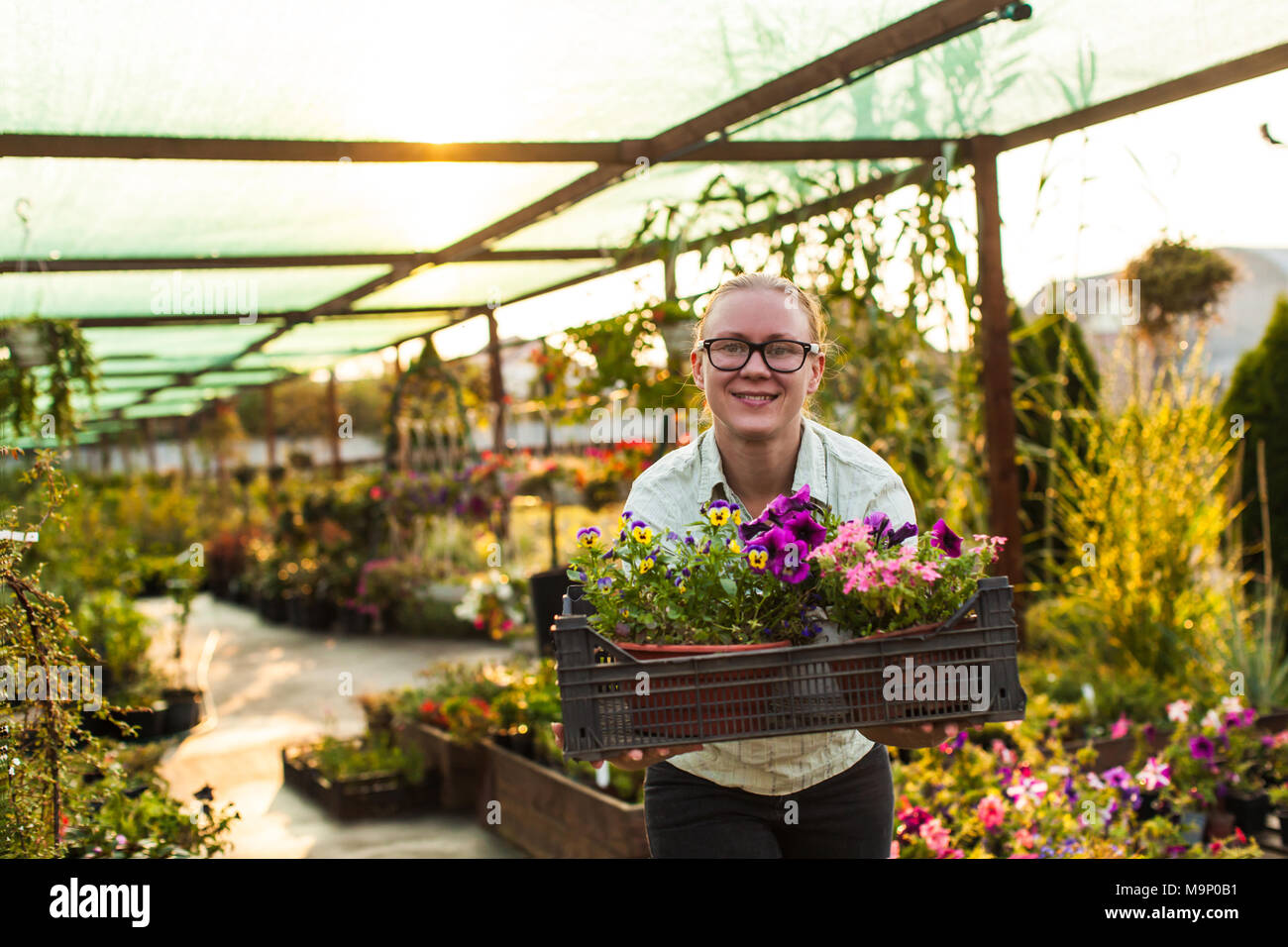 Happy gardener with plant Stock Photo - Alamy