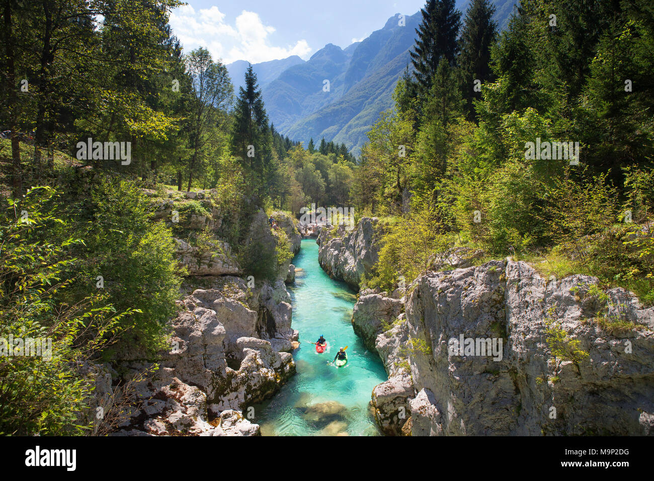 Kayakers on Soca river originating in Trigval mountains. The river is famous for all kinds of white water activities, Triglav National Park, Slovenia Stock Photo