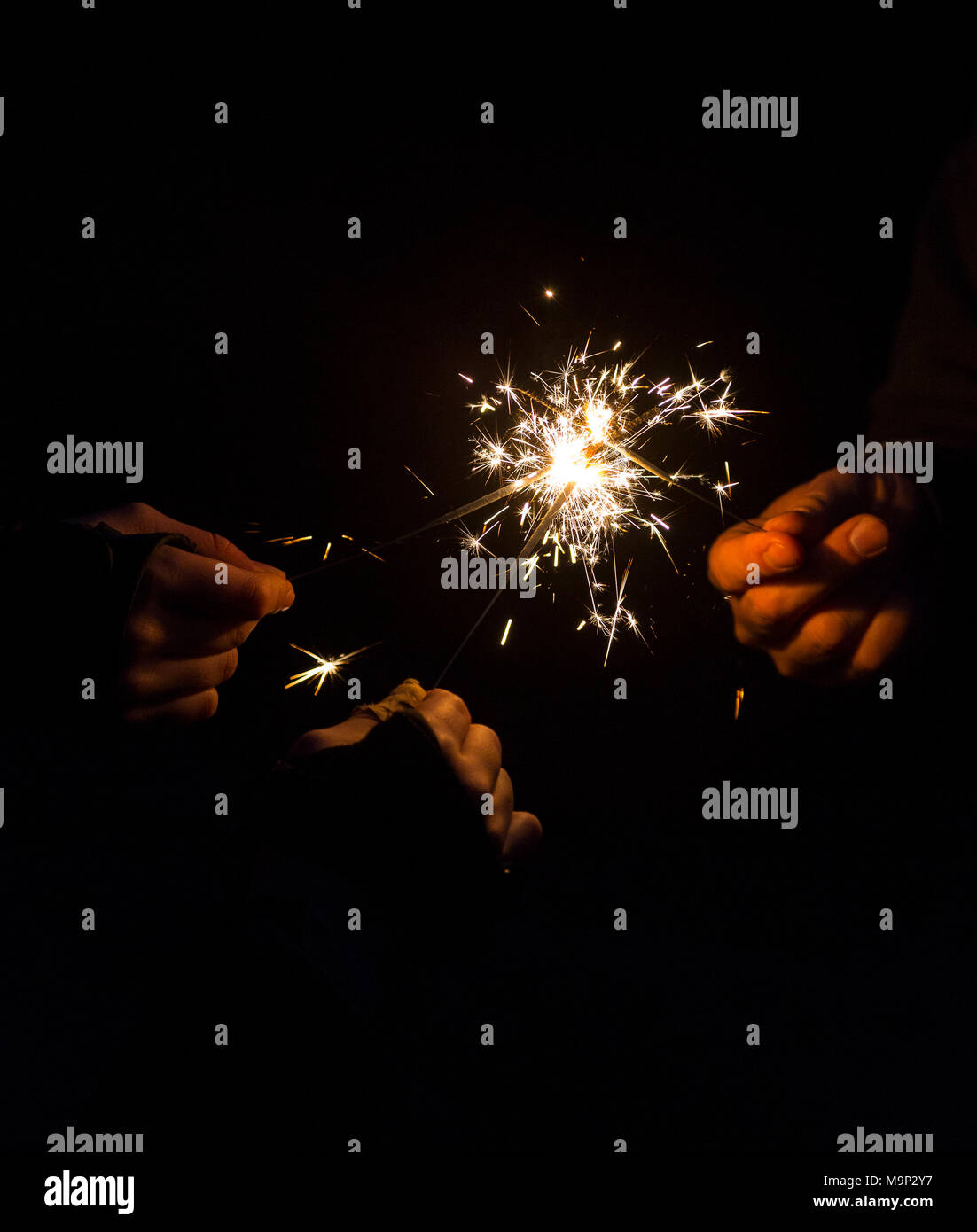 Burning sparklers in hands, symbil image party, fireworks, New Year's Eve Stock Photo