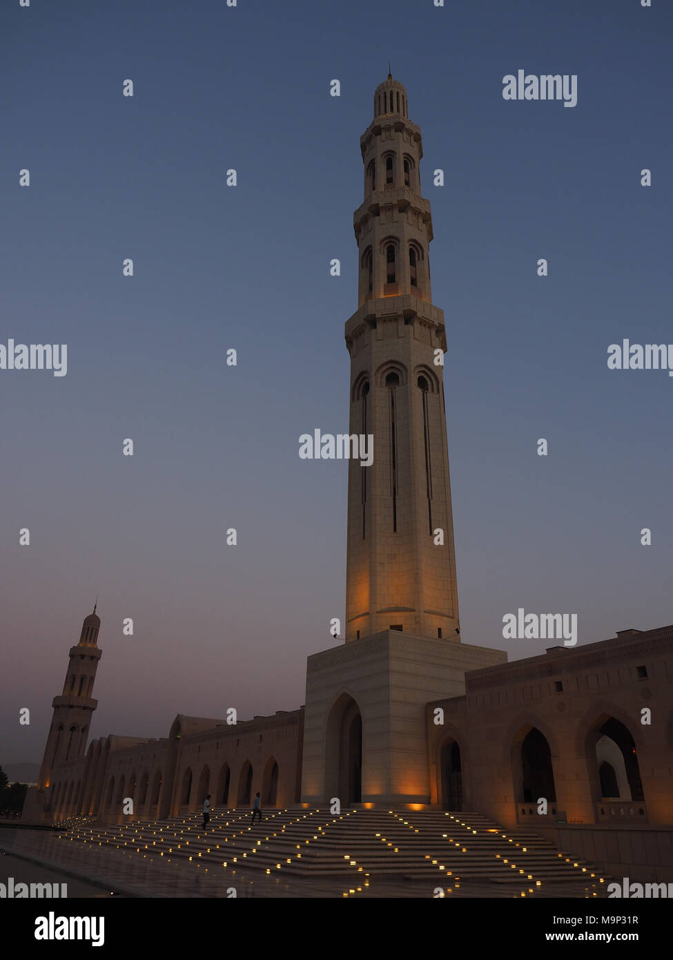 Evening atmosphere, illuminated Great Sultan Qabus Mosque and Minaret, Muscat, Oman Stock Photo