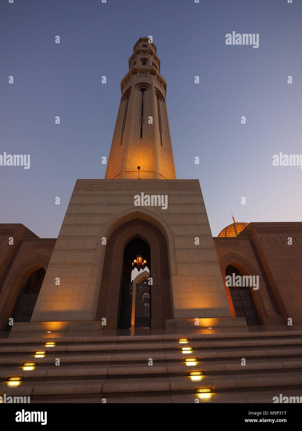 Evening atmosphere, illuminated Great Sultan Qabus Mosque and Minaret, Muscat, Oman Stock Photo