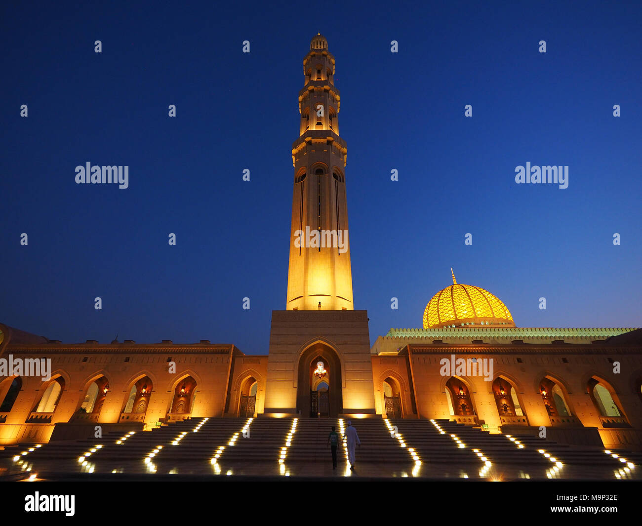 Evening atmosphere, illuminated Great Sultan Qabus Mosque with minaret, Muscat, Oman Stock Photo