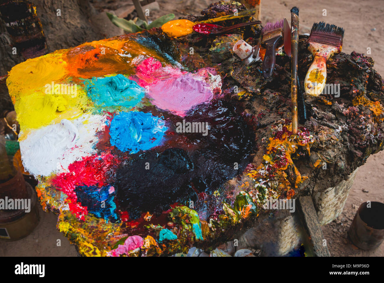 Colour palette, colourful painting palette of a painter, artist, with different oil colours and brushes Stock Photo