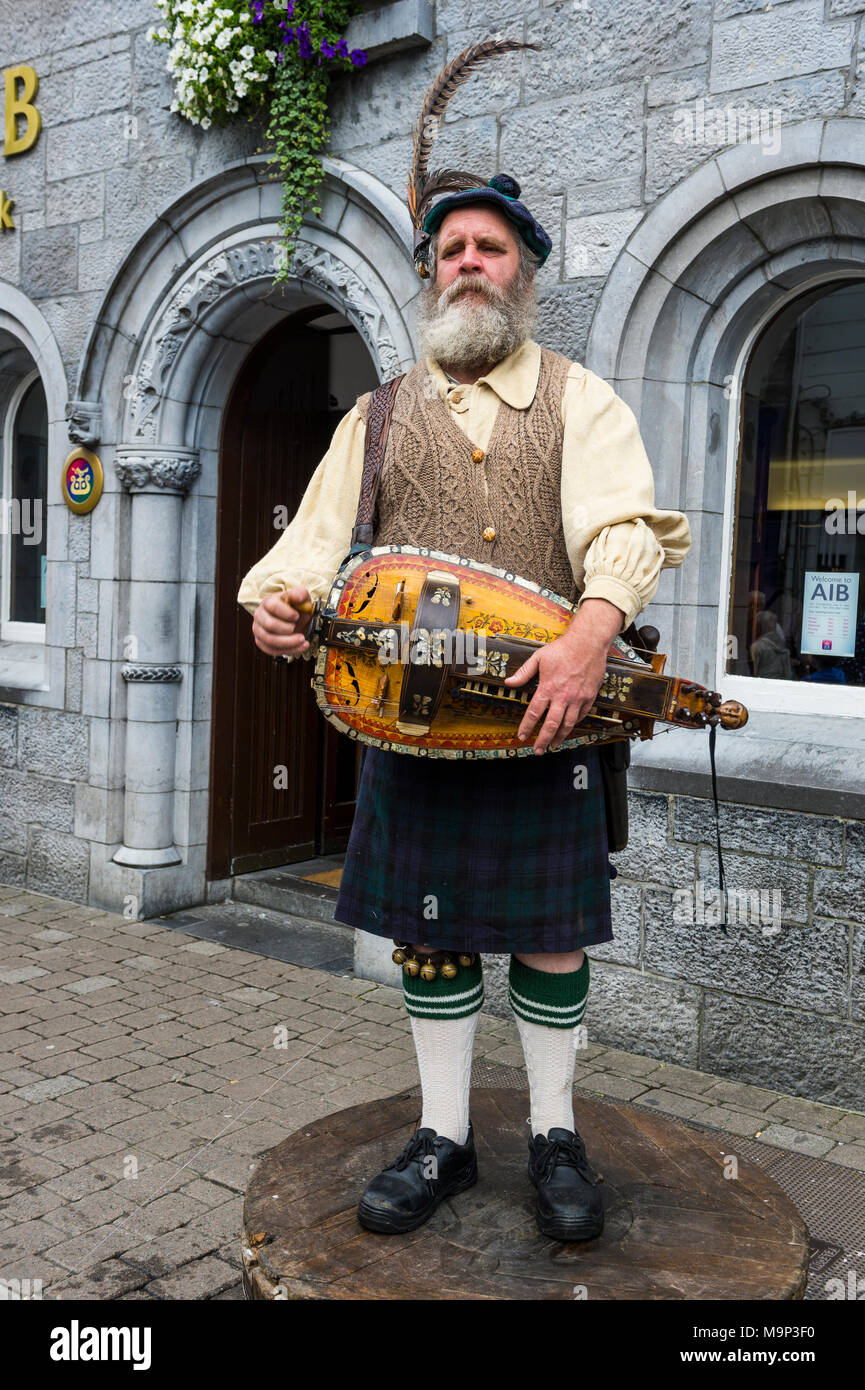 Traditional dressed man playing an old traditional instrument, Ireland Stock Photo