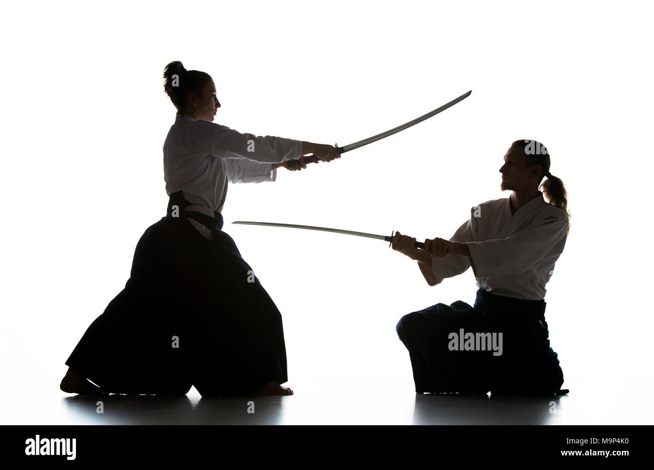 https://c8.alamy.com/comp/M9P4K0/man-and-woman-fighting-and-training-aikido-on-white-studio-background-M9P4K0.jpg
