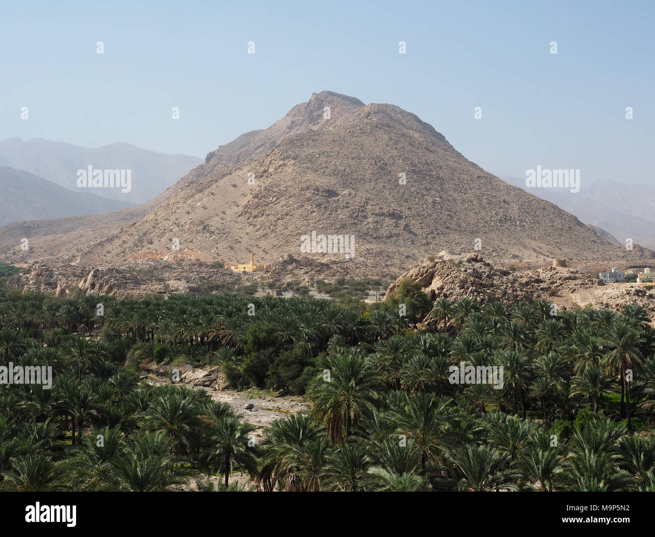 Al Hajar Mountains, in front palm oasis, view from the fortress Nakhl, Nakhl, Oman Stock Photo