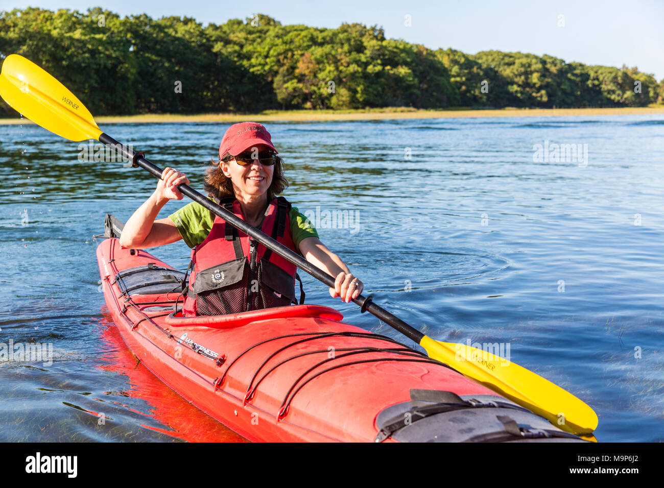 Woman in kayak on Essex River at Cox Reservation in Essex, Massachusetts Stock Photo