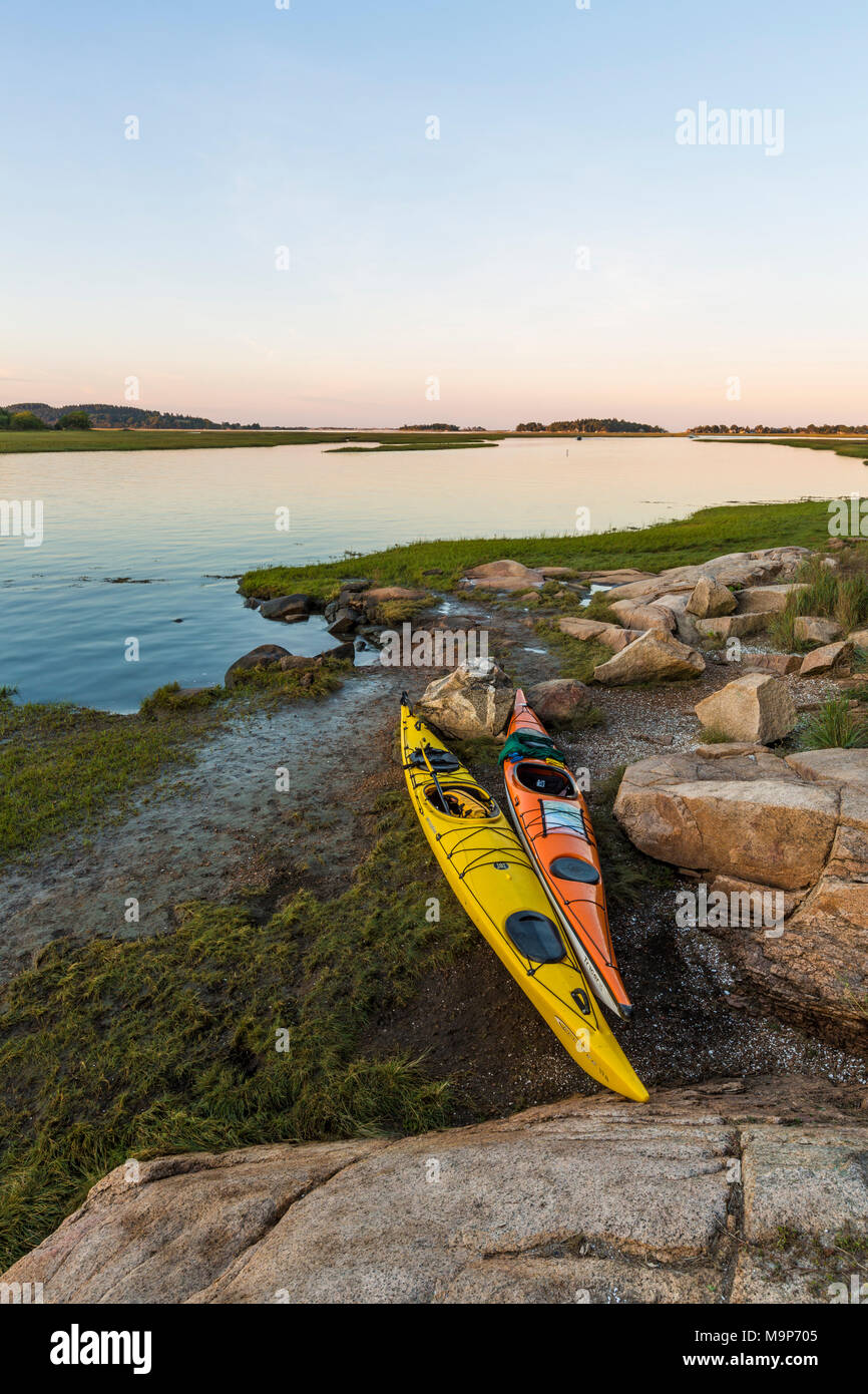 Pair of kayaks next to Essex River at Cox Reservation in Essex, Massachusetts Stock Photo