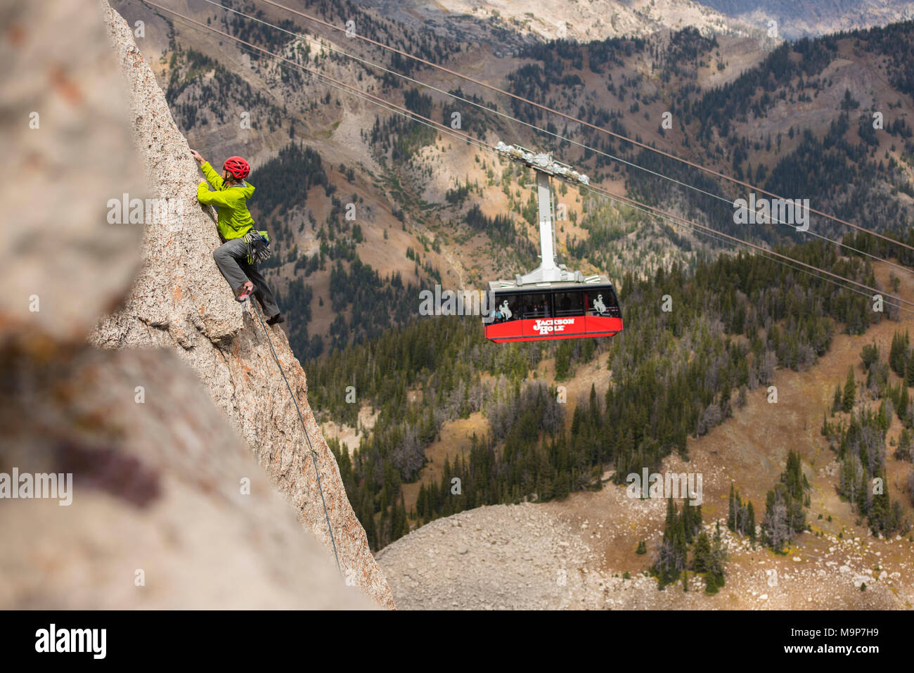 Man climbing at Corbet Couloir with iconic red gondola in background, Jackson Hole, WY, USA Stock Photo