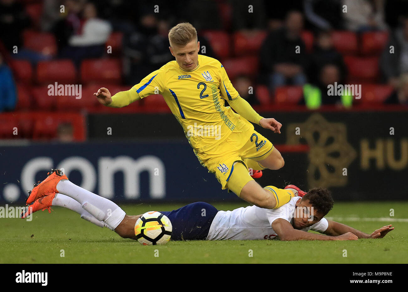 England U21's Dominic Calvert-Lewin goes to ground battling with Ukraine U21's Pavlo Lukyanchuk during the UEFA European U21 Championship Qualifying, Group 4 match at Bramall Lane, Sheffield. Stock Photo