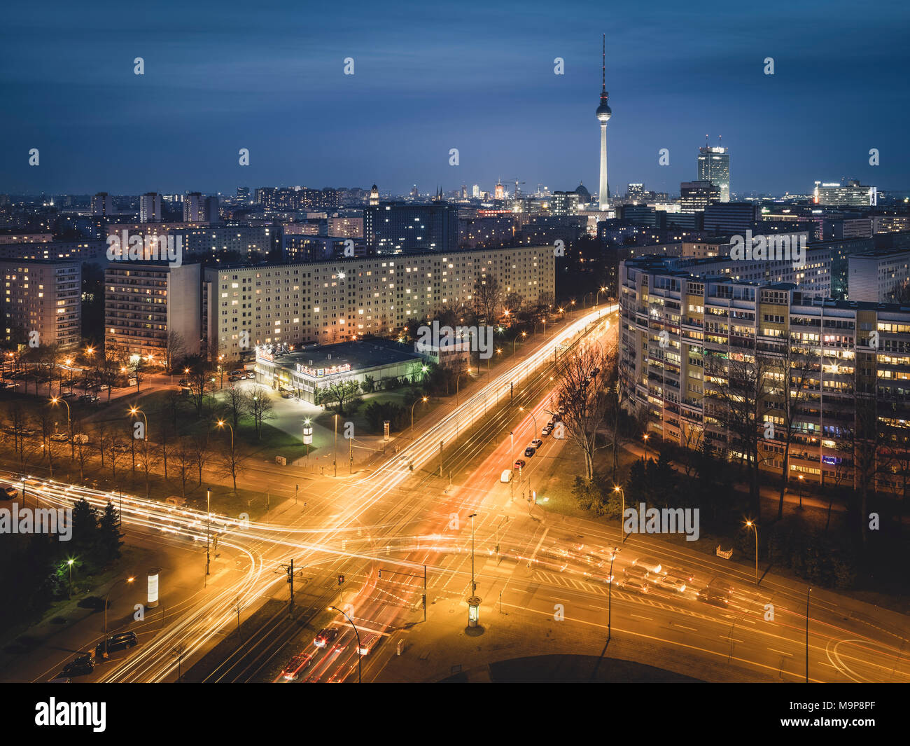 Traces of Light, Illuminated Crossing, Berlin Television Tower and Platz der Vereinten Nationen in the Evening, Berlin, Germany Stock Photo