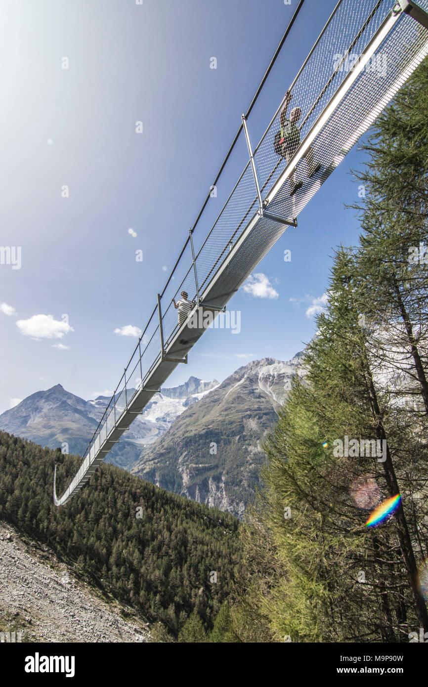 Low angle view of Worlds Longest Pedestrian Suspension Bridge during daytime, Randa, Wallis, Switzerland Stock Photo