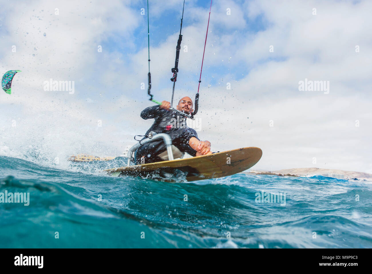 Action photo of a handicapped kite surfer Stock Photo