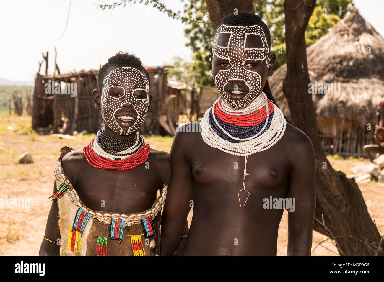 Two young girls with face painting, Karo tribe, in the back Karo village, Southern Nations Nationalities and Peoples' Region Stock Photo