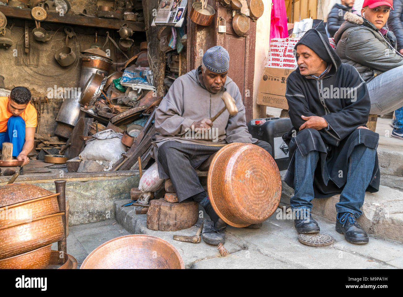 Coppersmiths at work, Place Seffarine, Fez, Morocco Stock Photo