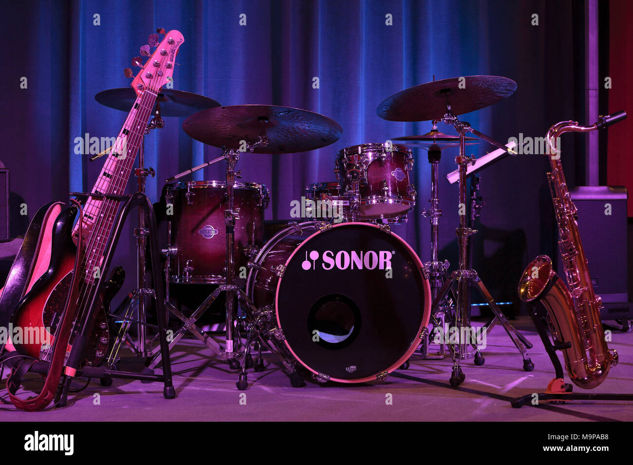 Instruments of a jazz band on stage, big band, electric bass, drums and saxophone Stock Photo