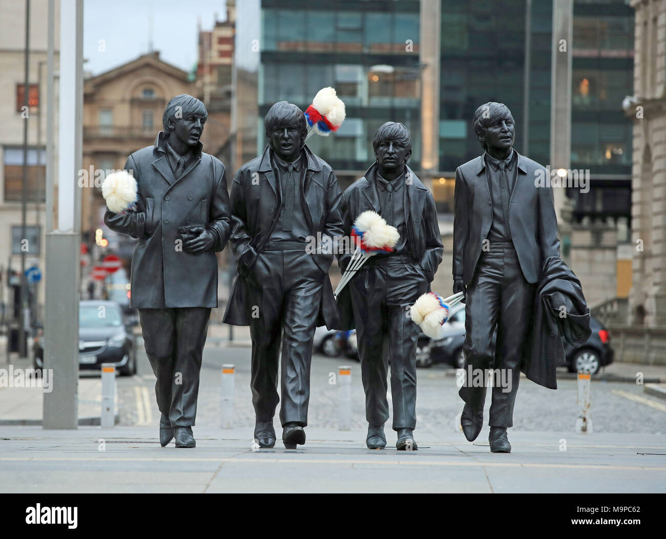 Tickling sticks are placed on the Beatles statue on Liverpool's