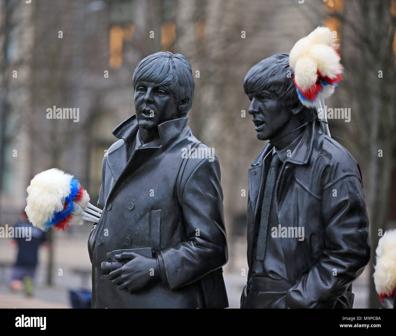 Tickling sticks are placed on the Beatles statue on Liverpool's