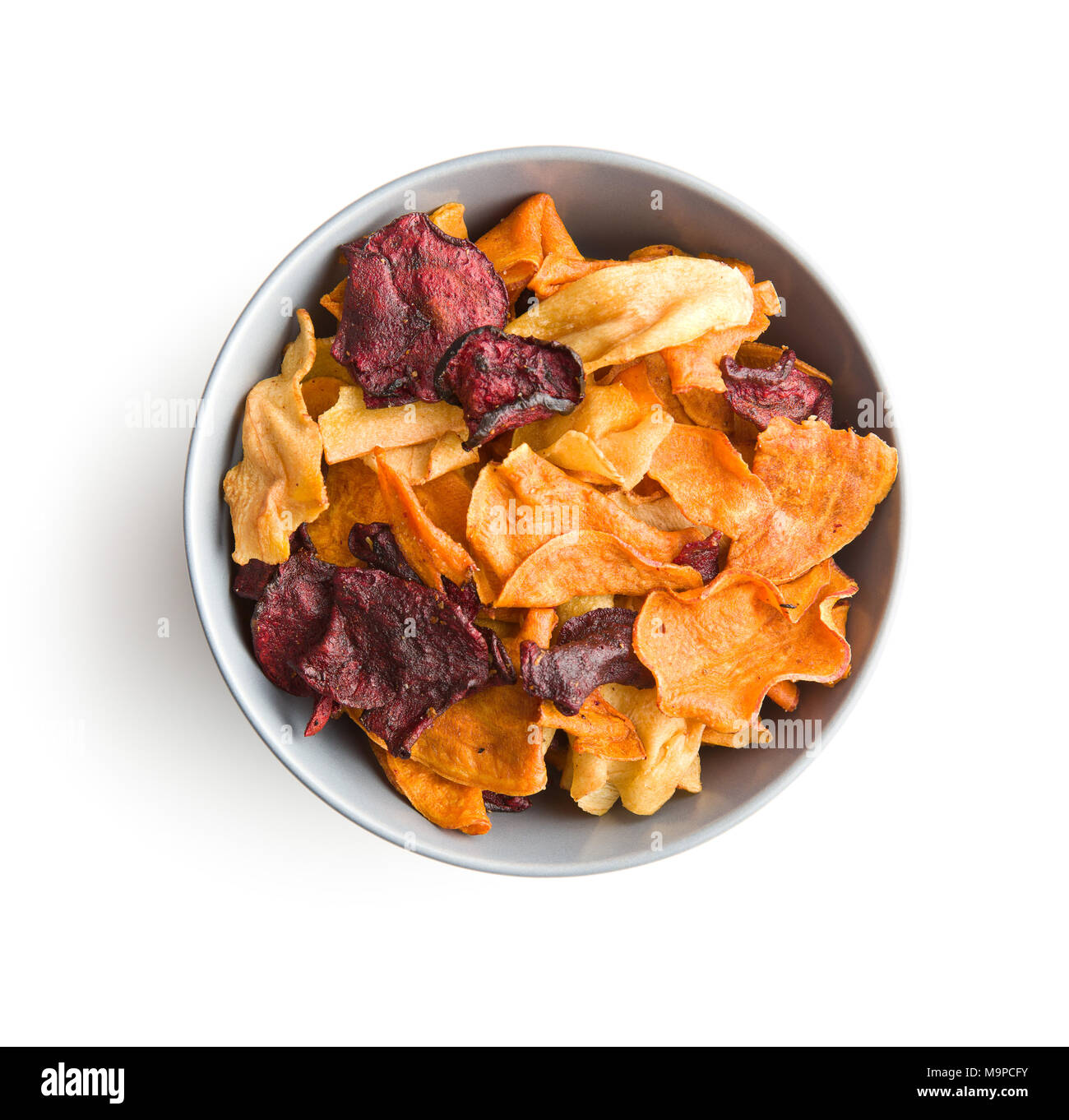 Mixed fried vegetable chips in bowl isolated on white background Stock
