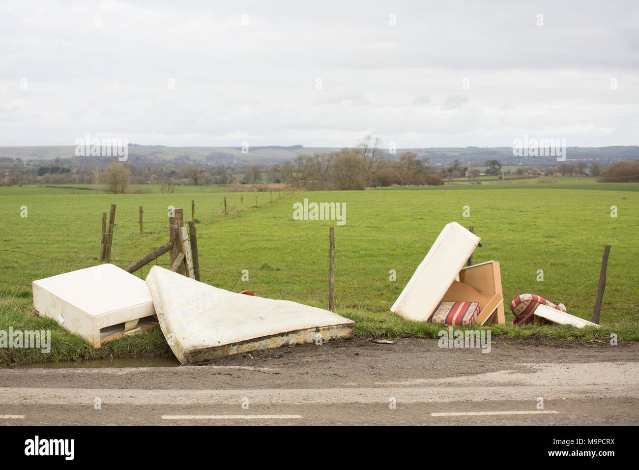 Mattresses and furniture dumped  in a lay-by near Gillingham, Dorset England UK GB Stock Photo