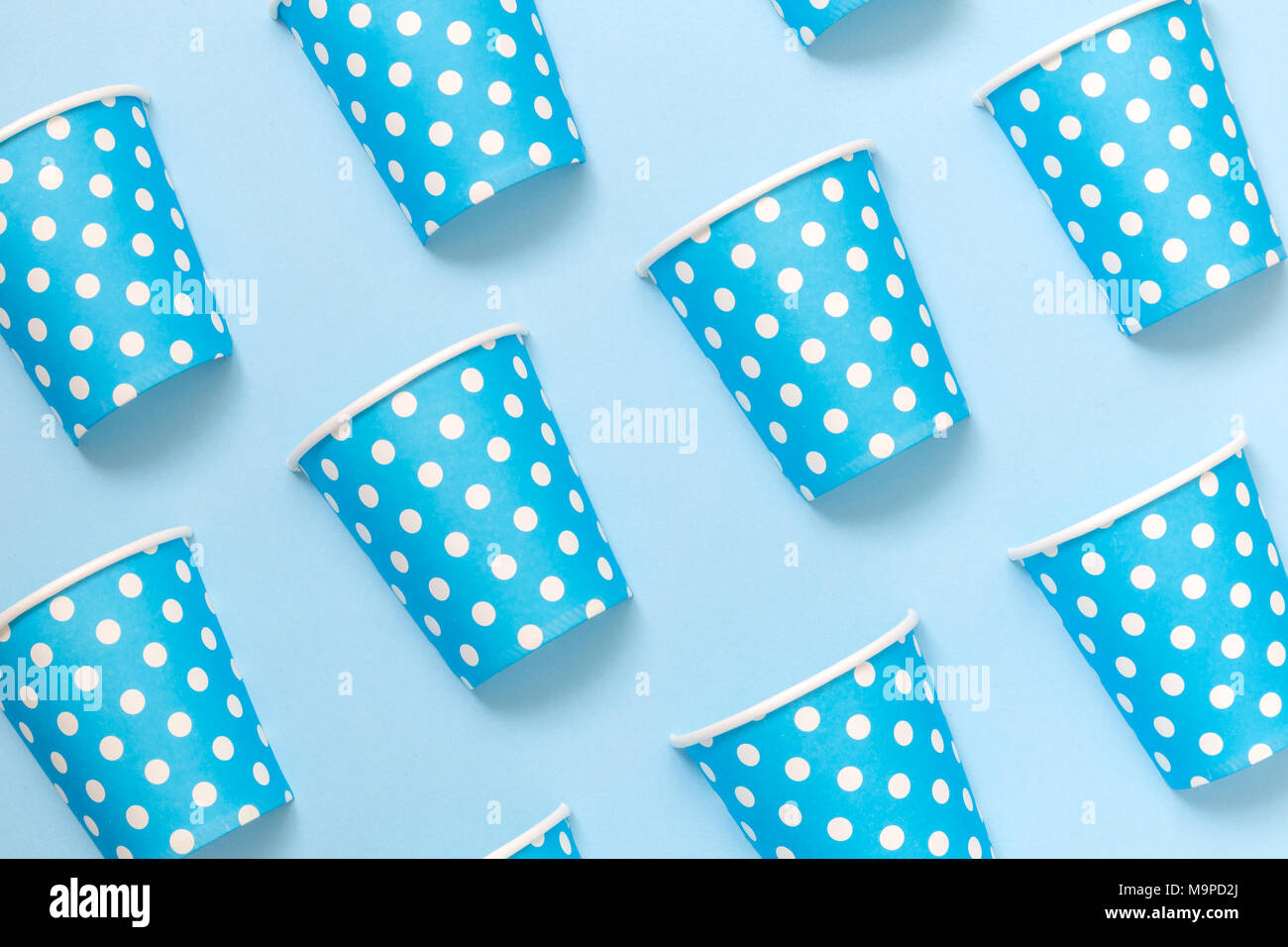 Paper cups polka design pattern on blue background minimal creative ...