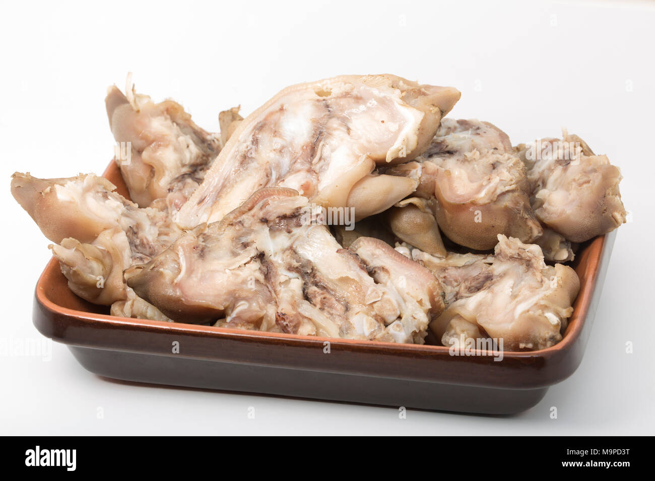 Pigs trotters that have been boiled until tender and split and left to cool before being eaten with a splash of vinegar UK. Pigs trotters are rich in Stock Photo