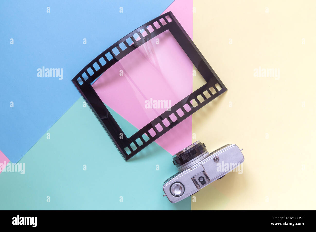 Retro film camera and photo frame isolated on colorful pastel ...