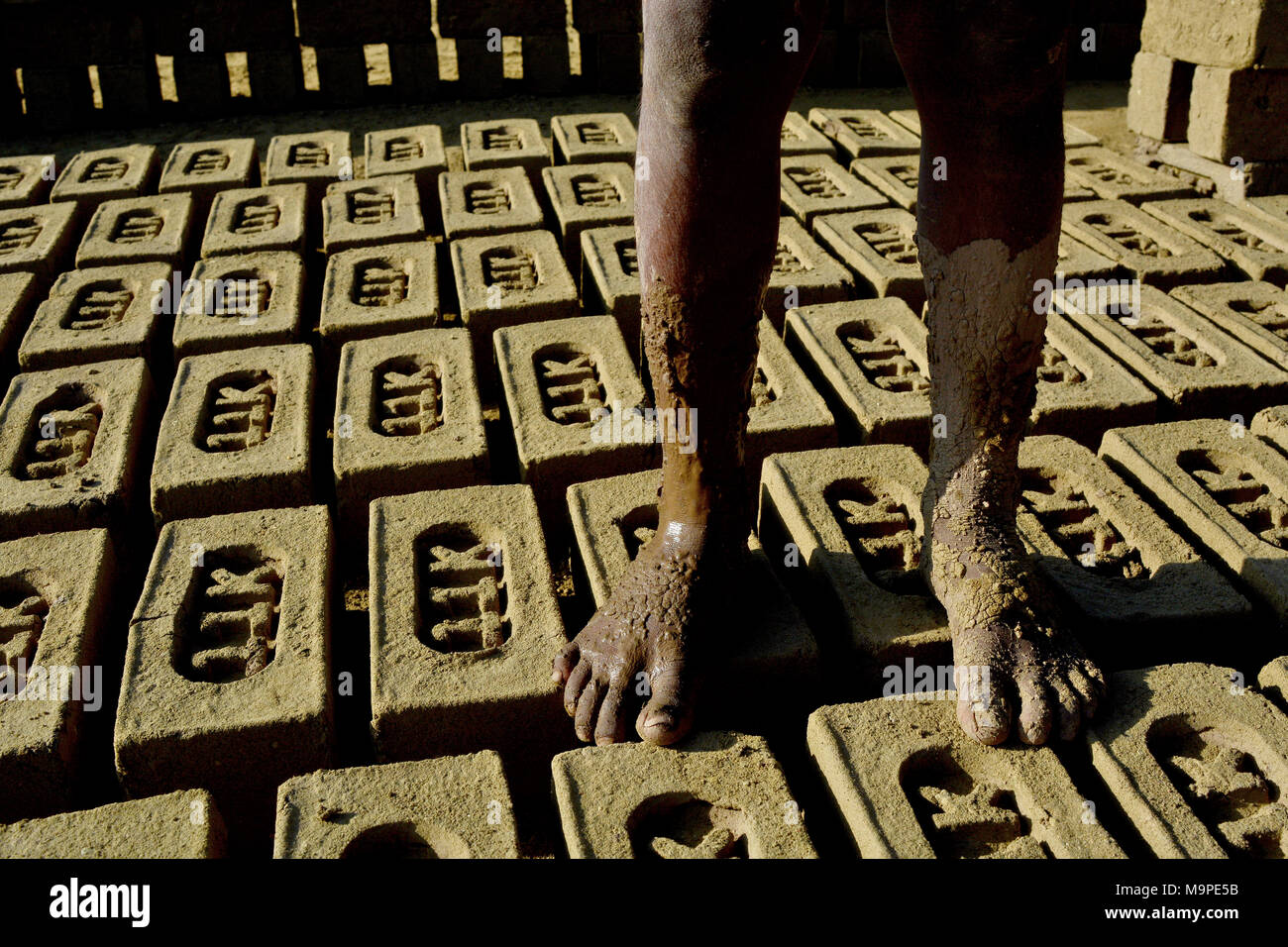 NonKashmiri laborer after prepared mud for bricks inside a brick kiln