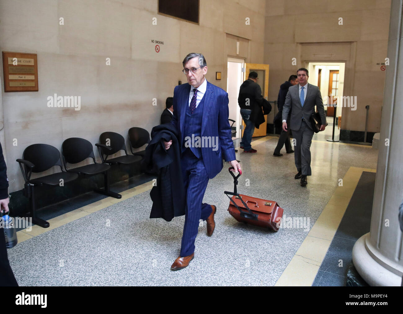 Nassau County, USA. 27th Mar, 2018. Chinese comedian Zhou Libo's lawyer Stephen Scaring (C) walks to a courtroom for the second preliminary hearing in Nassau County Court in Nassau County, New York, the United States, March 27, 2018. The Nassau County Court in New York in eastern coast state of New York on Monday resumed preliminary hearing of the case of Chinese comedian Zhou Libo, who is facing weapon and drug charges. With no further witness being summoned, the judge declared the court would resume on May 9. Credit: Wang Ying/Xinhua/Alamy Live News Stock Photo
