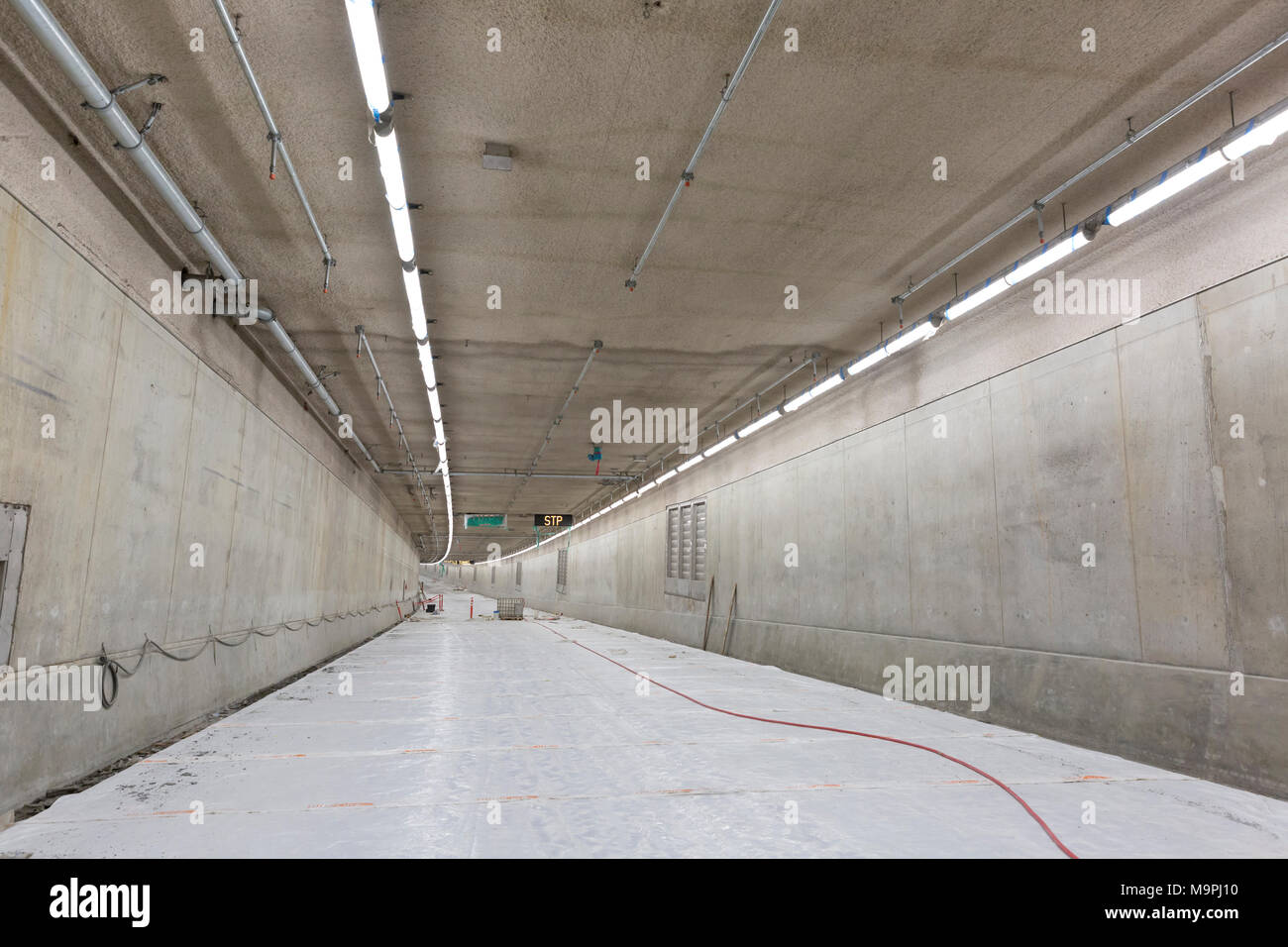 Seattle, Washington, USA. 27th Mar, 2018. The lower deck of the SR 99 Tunnel under construction. The Alaskan Way Viaduct Replacement Program’s road decks have been completed and the tunnel’s operational and safety systems are currently being installed. The bored road tunnel is replacing the Alaskan Way Viaduct and will carry State Route 99 under downtown Seattle from the SODO neighborhood to South Lake Union. Credit: Paul Christian Gordon/Alamy Live News Stock Photo