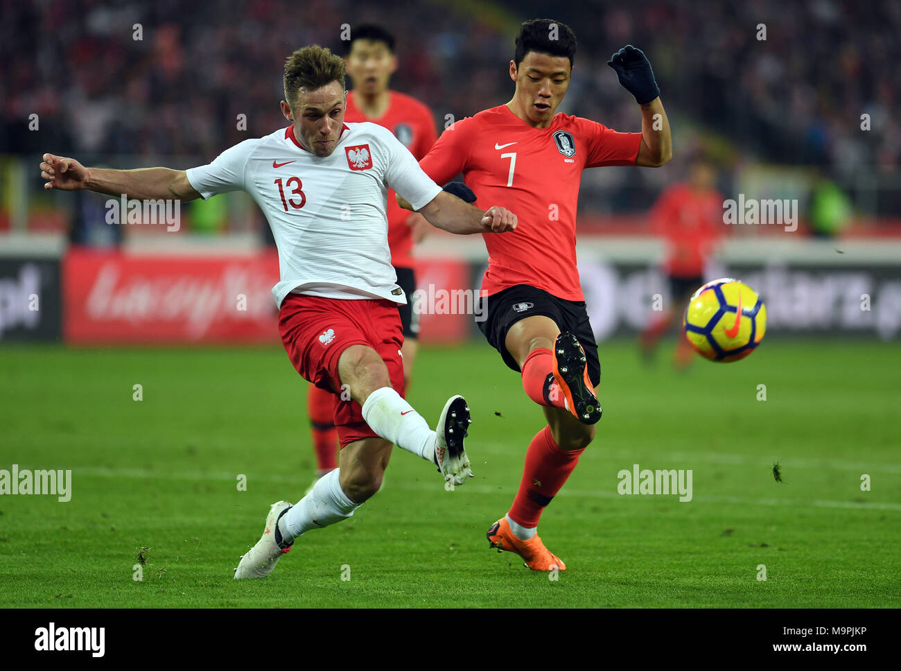 Chorzow, Poland. 27th Mar, 2018. Kwang Hee-chan (R) of South Korea vies with Maciej Rybus (L) of Poland during a friendly match between Poland and South Korea in Chorzow, Poland, on March 27, 2018. Poland won 3-2. Credit: Maciej Gillert/Xinhua/Alamy Live News Stock Photo