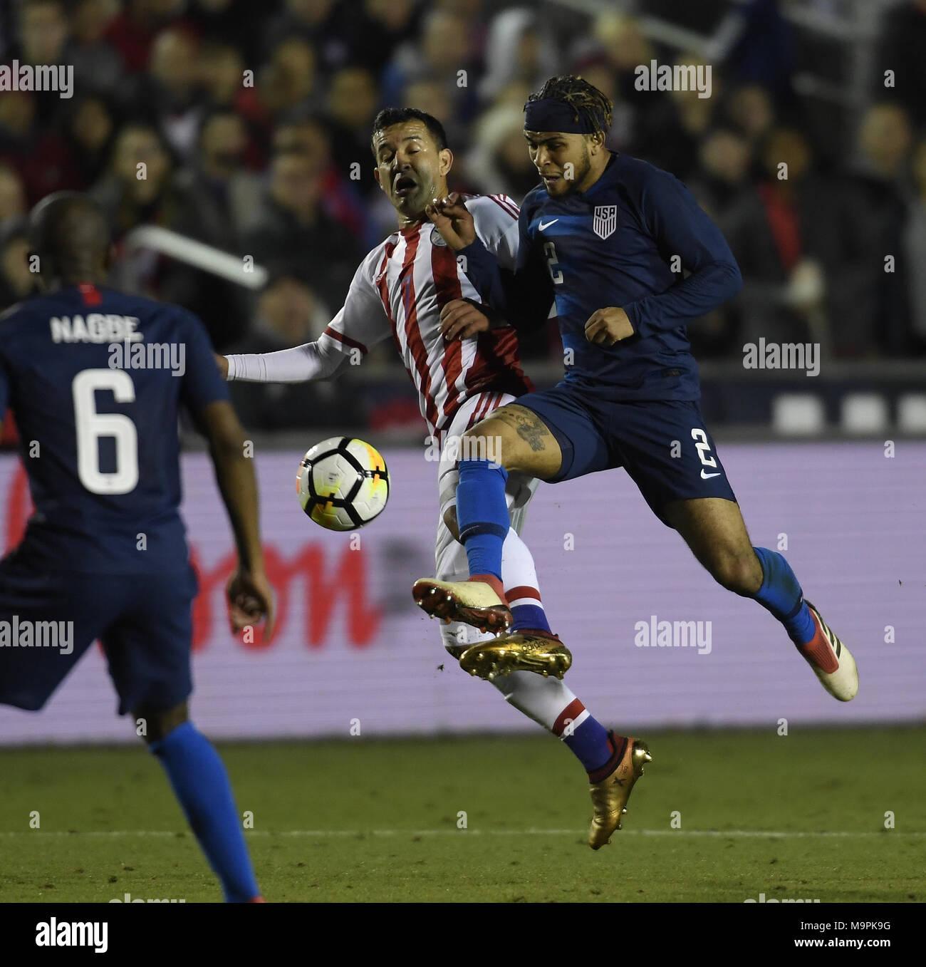 Cary, North Carolina, USA. 27th Mar, 2018. DEANDRE YEDLIN (2) of USA wins a ball against NESTOR CAMACHO, center, of Paraguay. The USA played Paraguay in a men soccer game that took place at the WakeMed Soccer Park in Cary, N.C. on Tuesday, March 27, 2018. USA won 1-0. Credit: Fabian Radulescu/ZUMA Wire/Alamy Live News Stock Photo