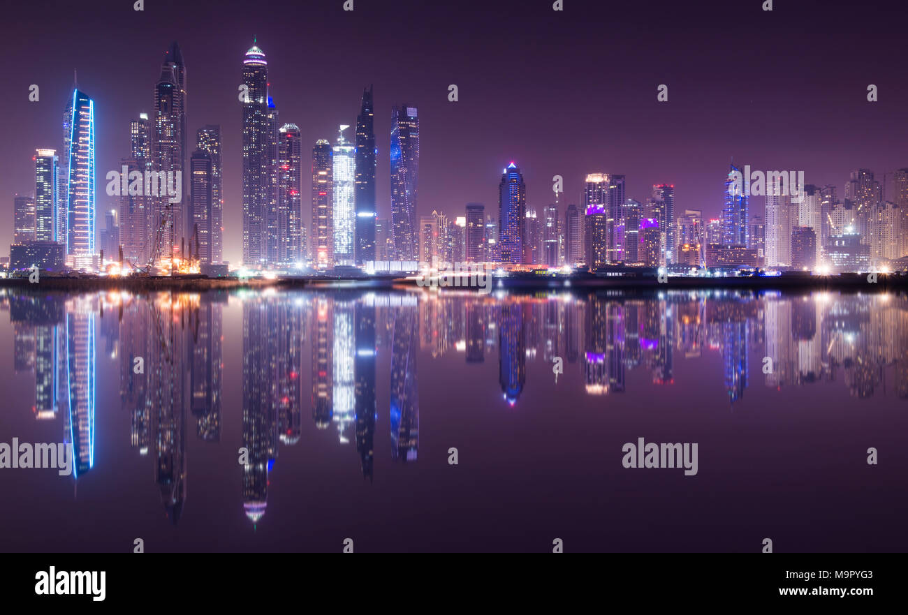 Panoramic view of Dubai Marina skyline with reflection at night, UAE Stock Photo