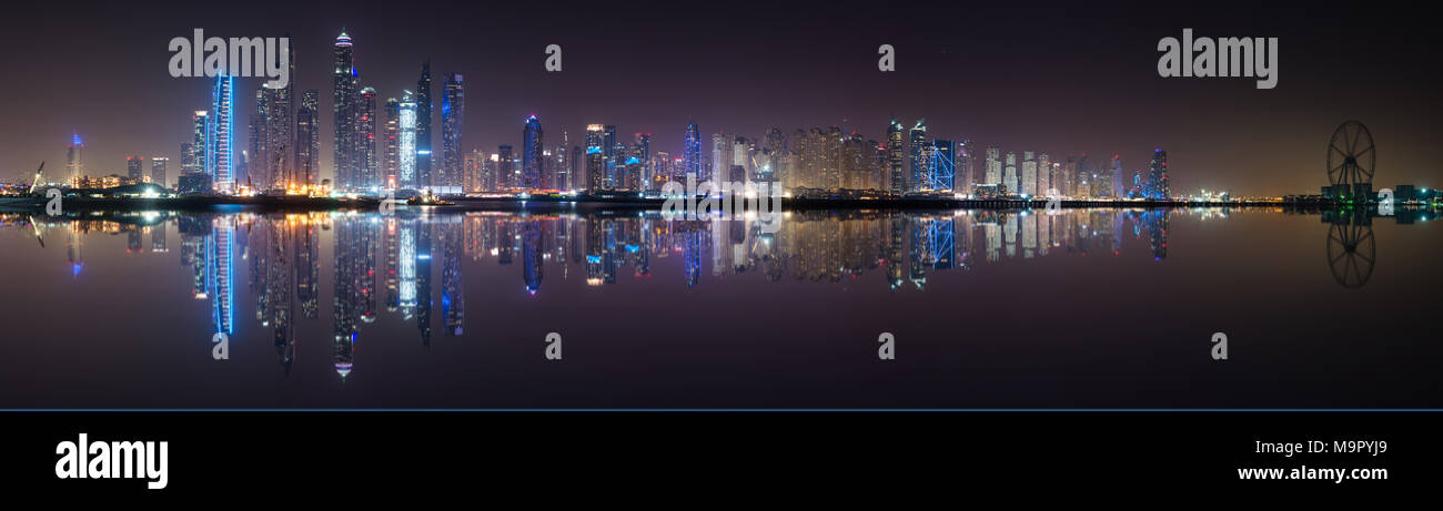 Panoramic view of Dubai Marina skyline with reflection at night, UAE Stock Photo
