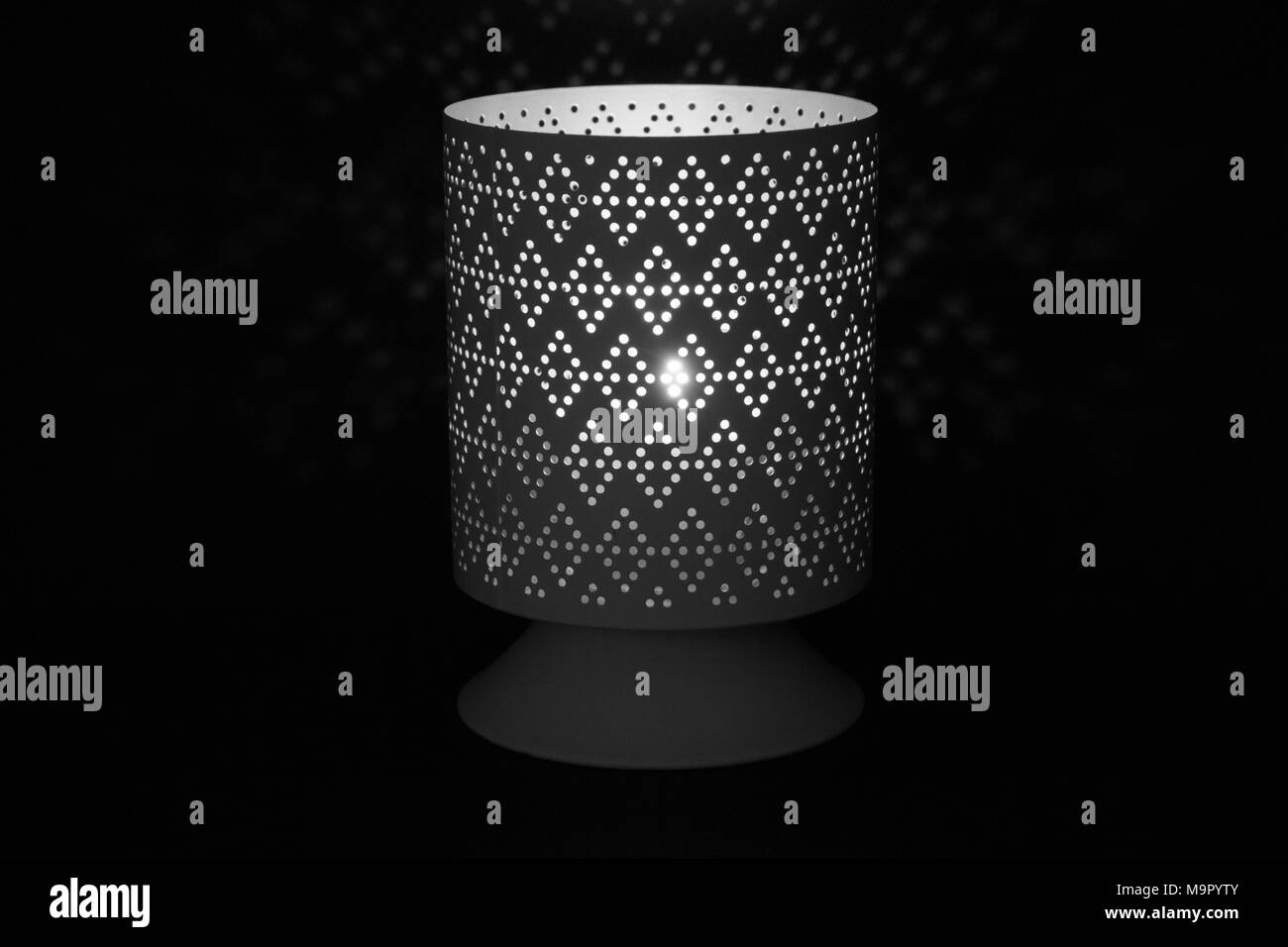 Lamp with Dark Background and Lace Design Stock Photo