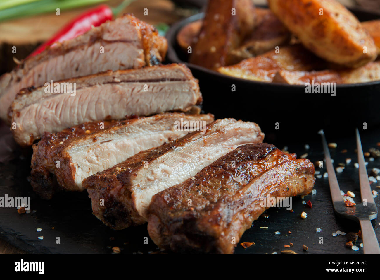 fried roasted pork ribs with potatoes and spices Stock Photo