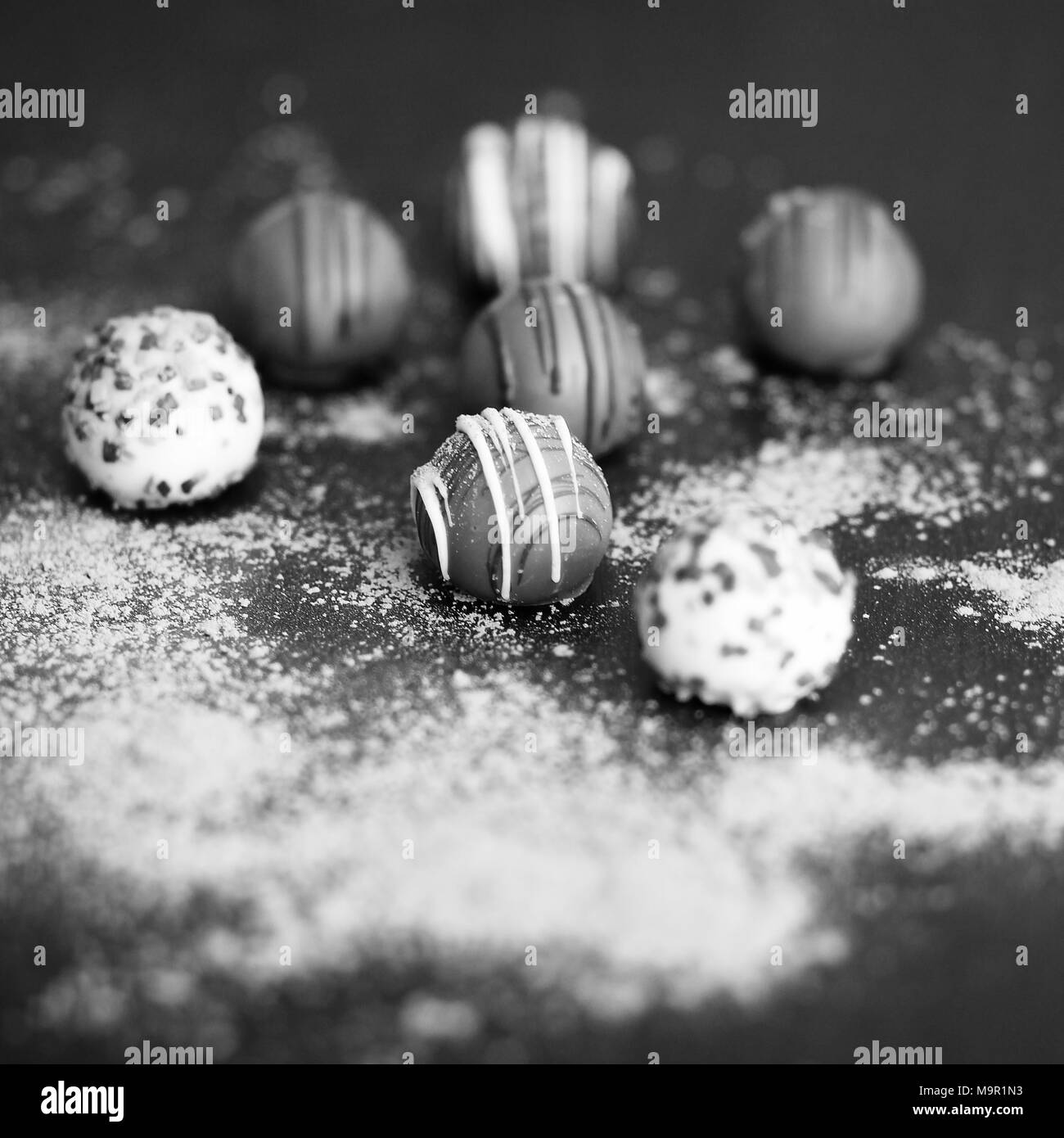 Chocolate truffles on wooden table in black and white Stock Photo