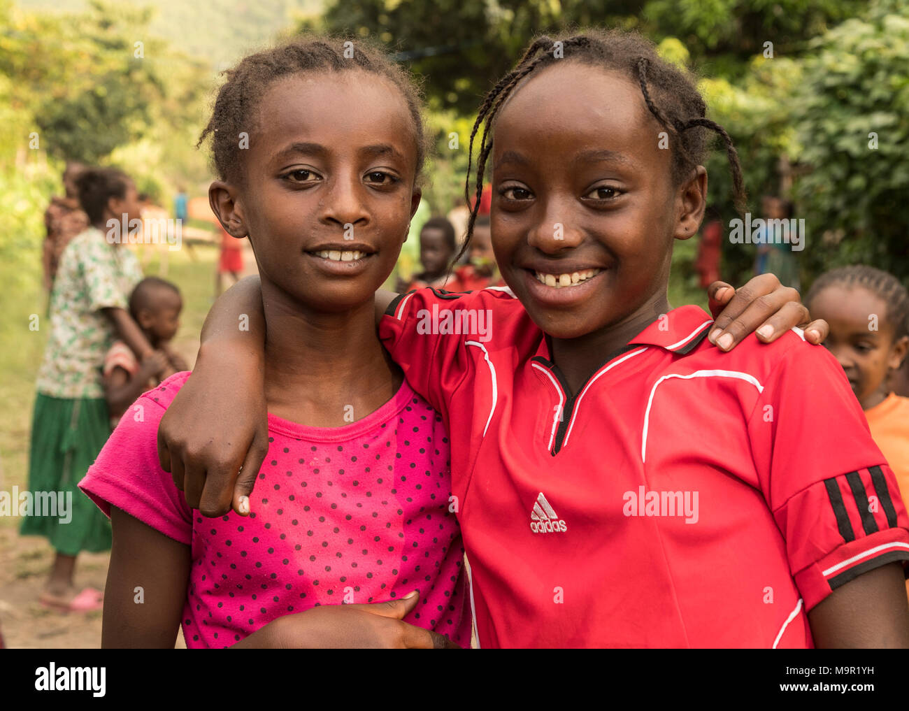 Two girls, about 10 years old, smiling with a view into the camera, portrait, Ari tribe, Southern Nations Nationalities and Stock Photo