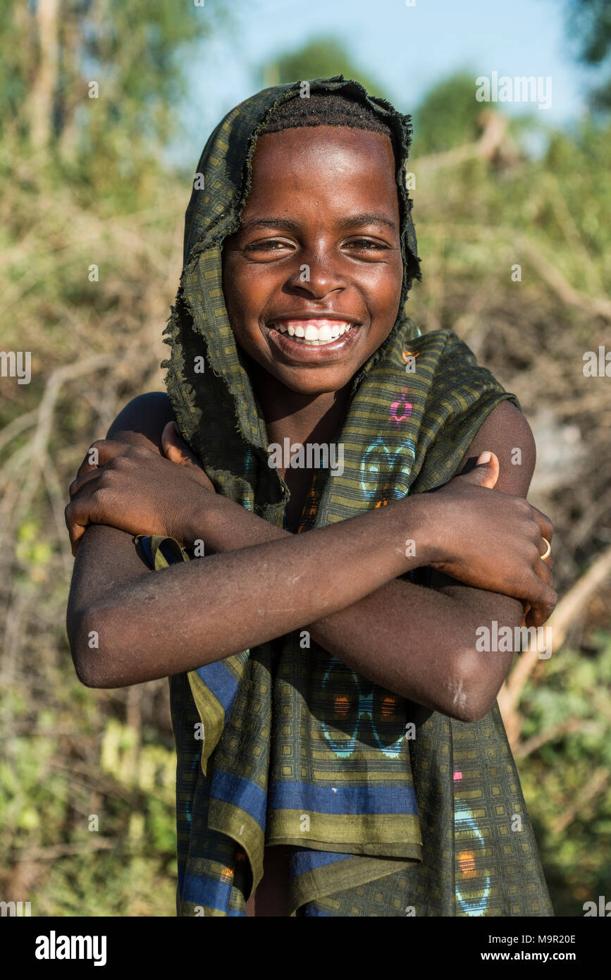 Young boy, approx. 12 years, posing smiling with crossed arms, Hamer tribe, Turmi market, Southern Nations Nationalities and Stock Photo