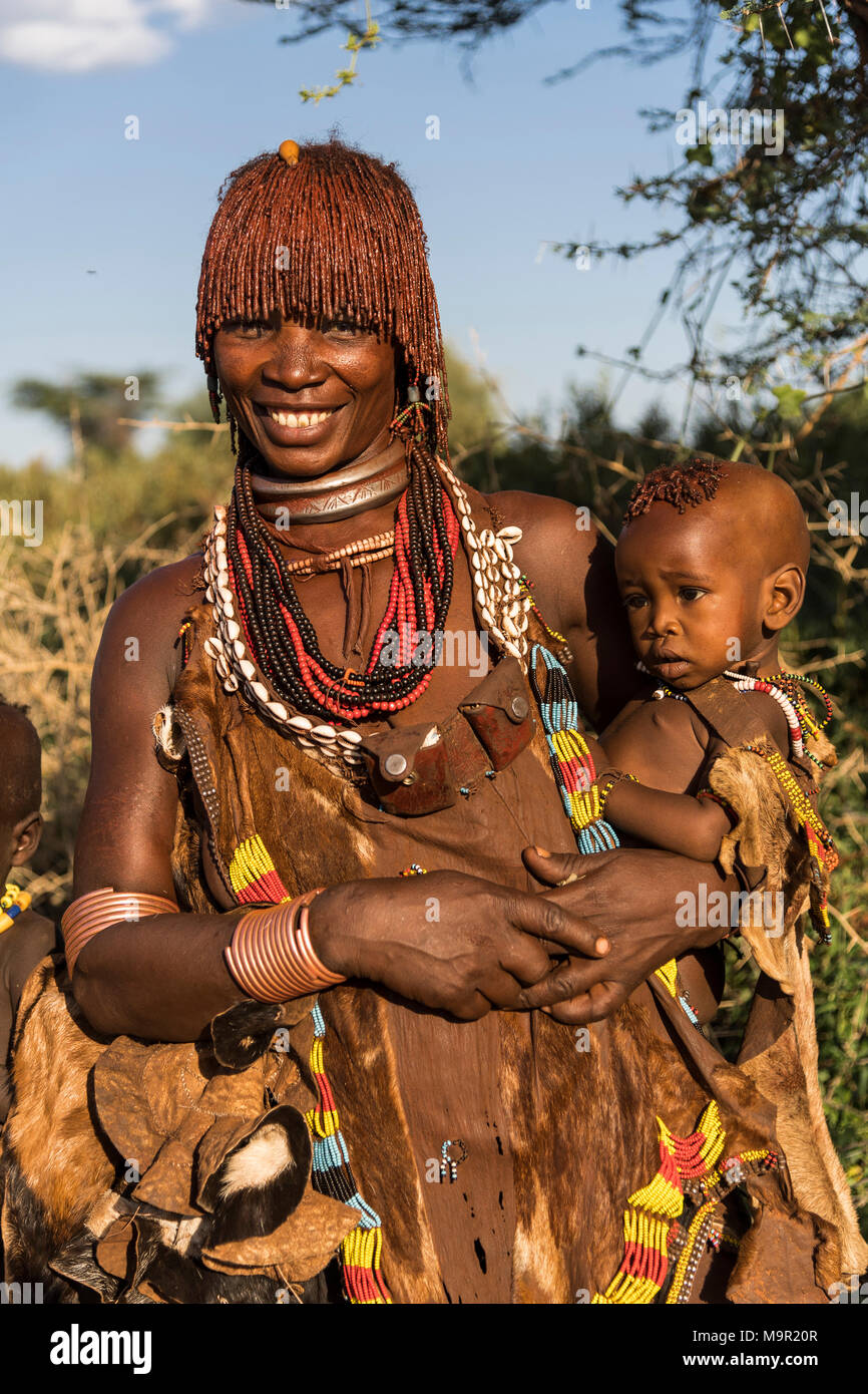 Woman with an infant in her arms, Hamer tribe, Turmi market, Southern Nations Nationalities and Peoples' Region, Ethiopia Stock Photo