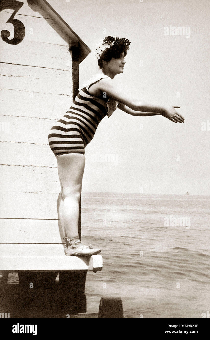 Woman in striped swimsuit wants to jump into the water, 1910s, Baltic Sea, Germany Stock Photo