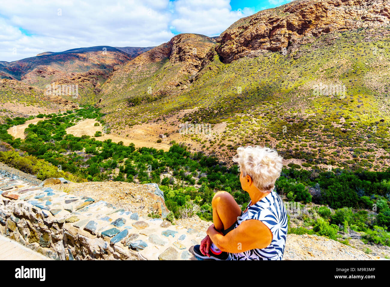 Senior woman enjoying the view of the Huisrivierpas, between Ladismith and Calitzdorp in the Little Karoo of the Western Cape Province of South Africa Stock Photo