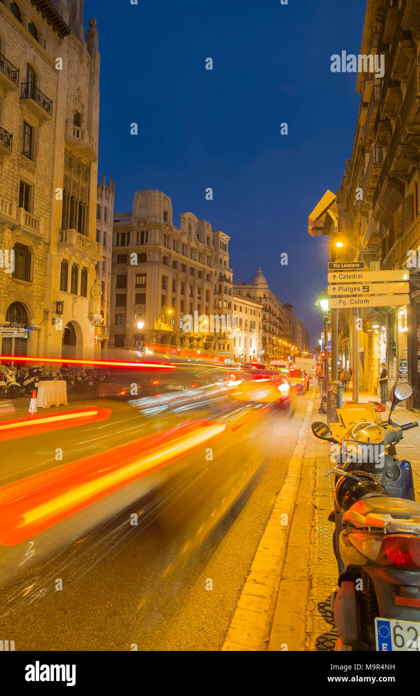 Vehicles speed down Via Laietana at night, in Barcelona, Spain Stock Photo