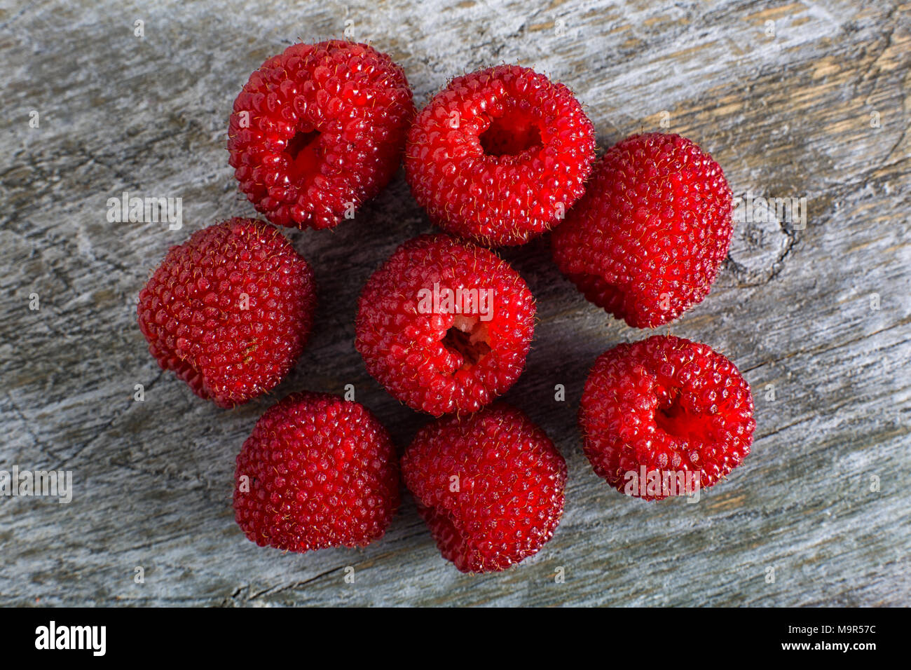 Ecuadorian raspberry variety closeup on rustic wood surface Stock Photo