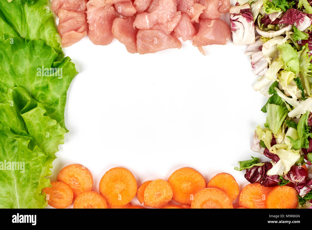 Frame of fresh vegetables and dietary meat isolated on the white background. Healthy natural food with copy space . Cooking ingredients top view, mockup for recipe or menu. Stock Photo