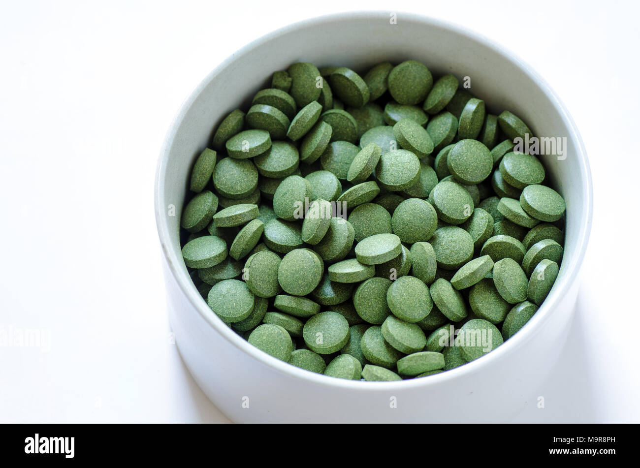 Green chlorella and spirulina pills. Nutritional supplement, healthy lifestyle, alternative natural medicine. Stock Photo