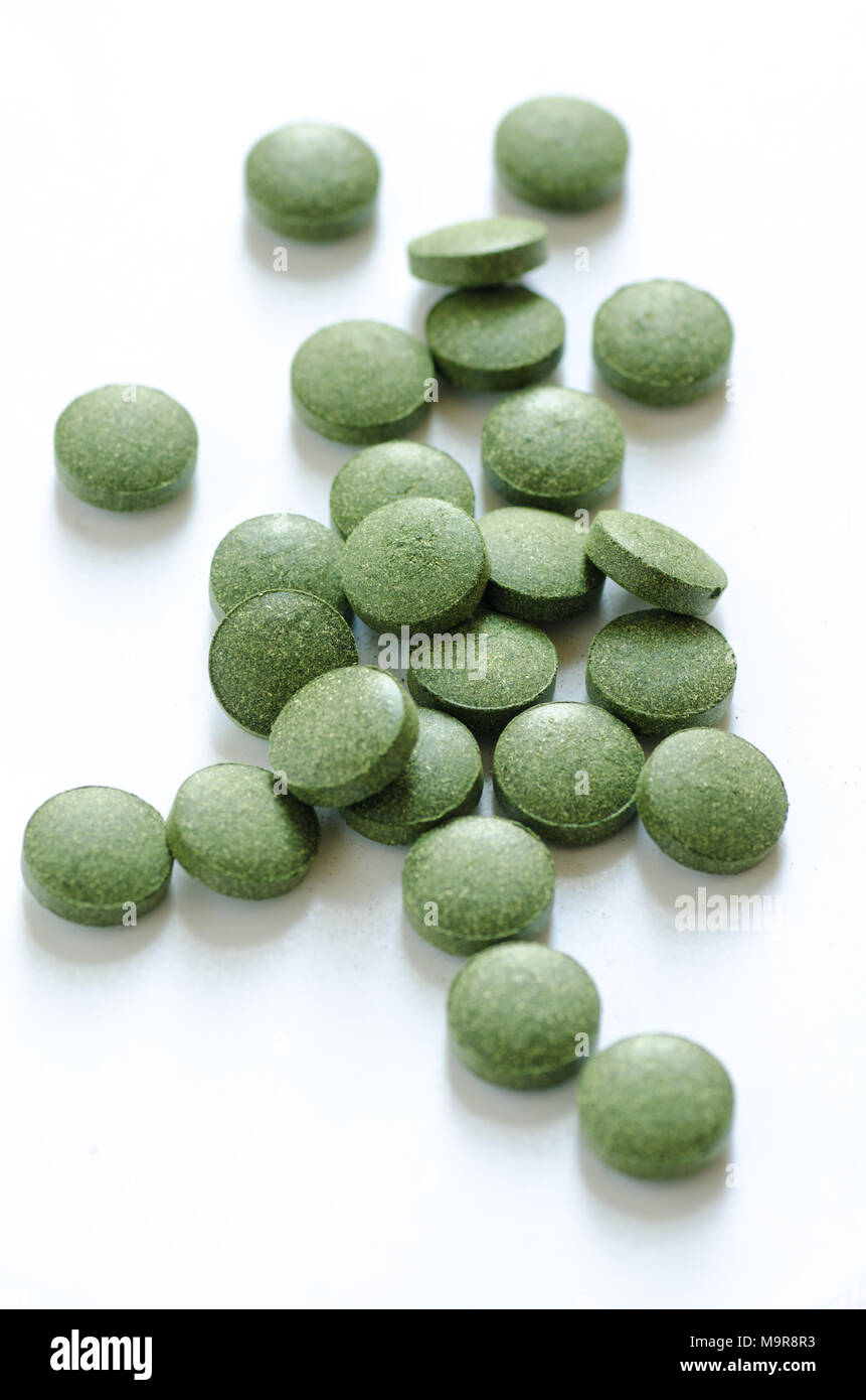 Green chlorella and spirulina pills. Nutritional supplement, healthy lifestyle, alternative natural medicine. Stock Photo