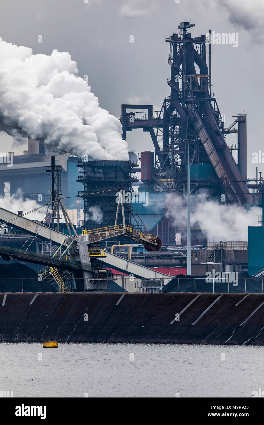 Factory Tata Steel with smoking chimneys on a sunny day, IJmuiden, The  Netherlands Stock Photo