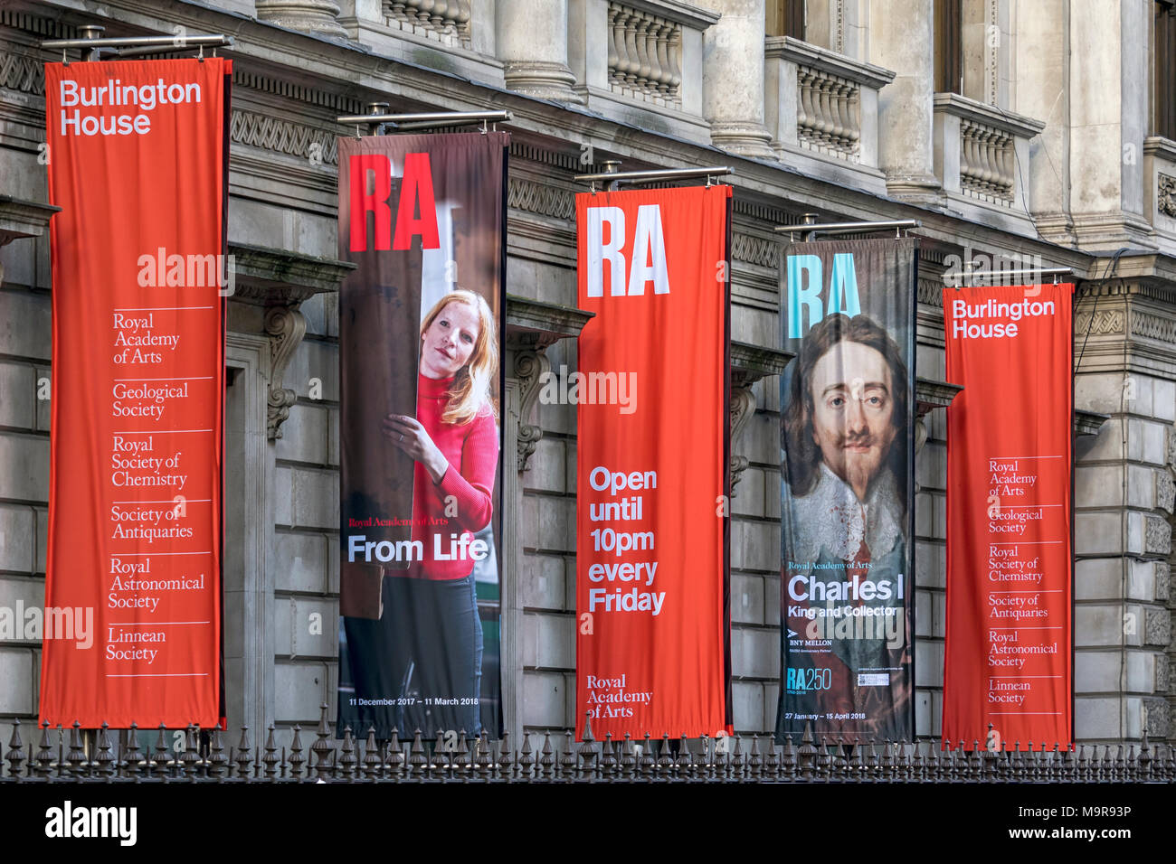 LONDON, UK - MARCH 08, 2018:  Colourful banners for Royal Academy of Arts outside Burlington House Stock Photo
