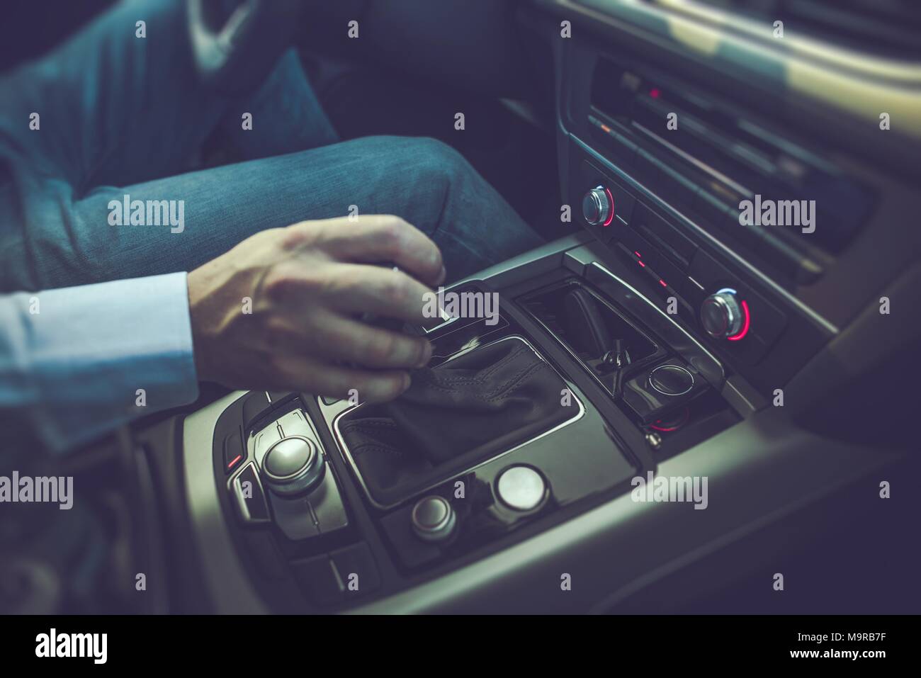 Caucasian Men Driving the Car. Shifting Automatic Transmission to Drive